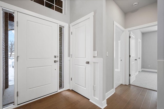 entrance foyer with baseboards and dark wood-type flooring