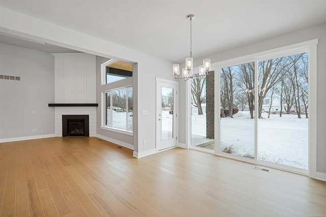 unfurnished dining area featuring a wealth of natural light, visible vents, and light wood-style flooring