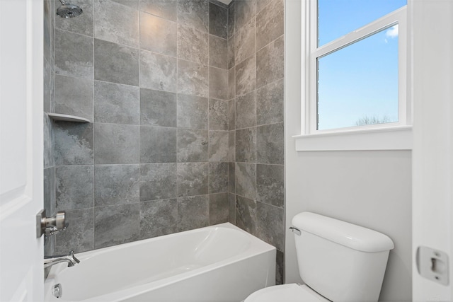 bathroom with washtub / shower combination and toilet