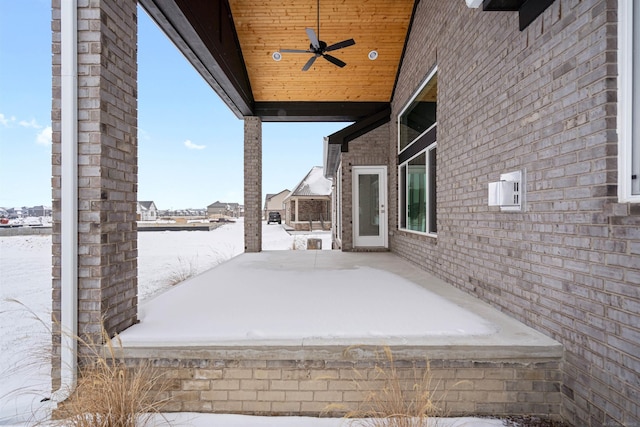 snow covered patio with a ceiling fan