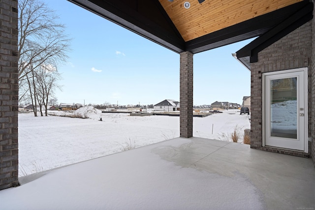 snowy yard featuring a patio