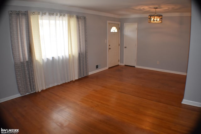 foyer entrance featuring wood finished floors and baseboards