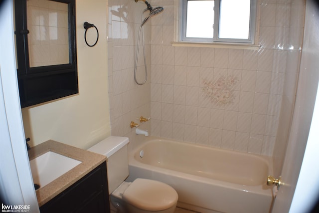 bathroom with toilet, tub / shower combination, and vanity