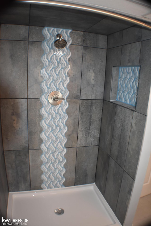 bathroom with a tile shower