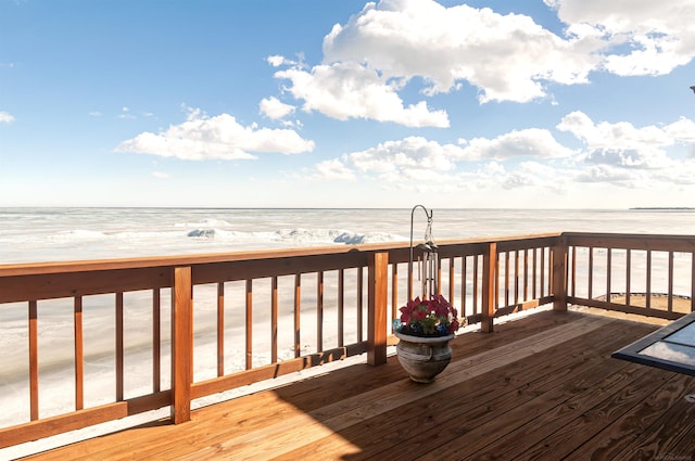 wooden terrace featuring a water view