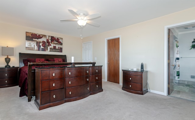 bedroom with ensuite bath, baseboards, visible vents, and light colored carpet