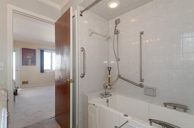 bathroom with shower / bath combination, baseboards, visible vents, and crown molding