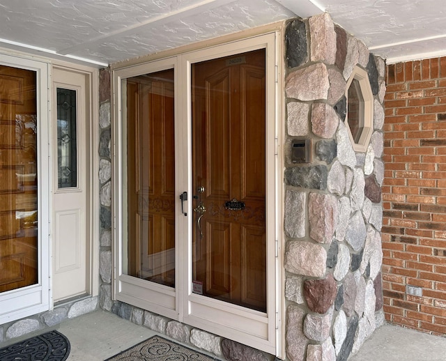 view of exterior entry with brick siding