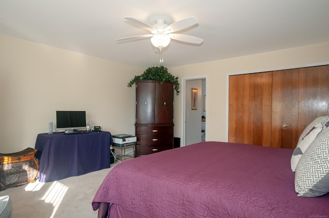 carpeted bedroom featuring a ceiling fan and a closet