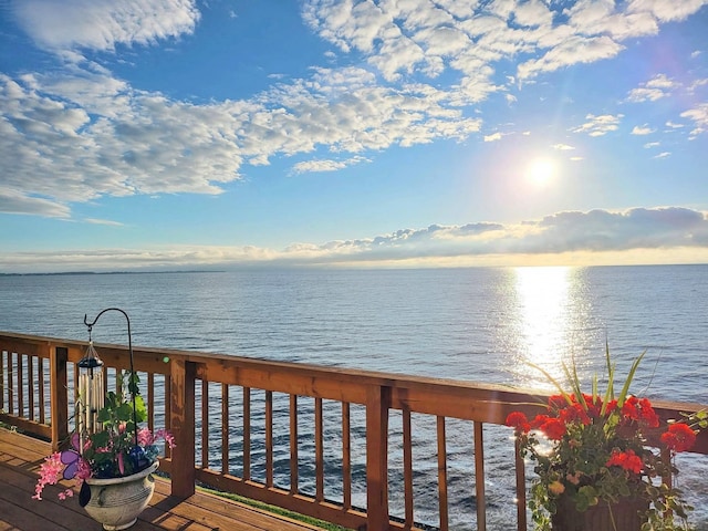 wooden terrace featuring a water view