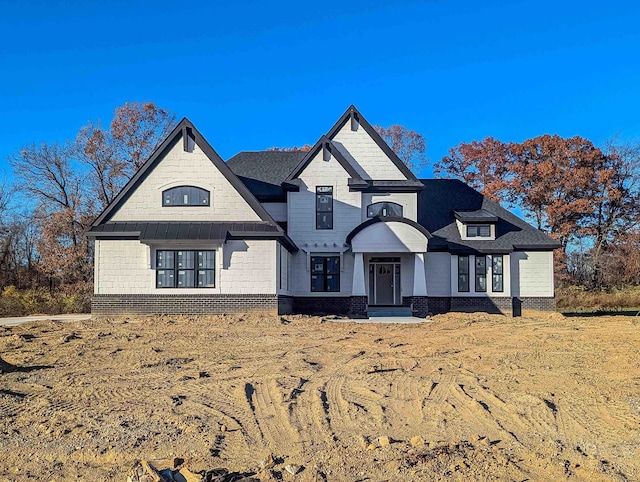 view of front of property featuring a standing seam roof and metal roof