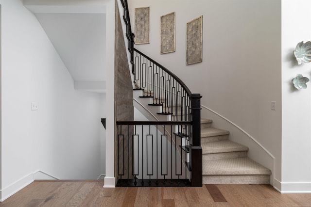 stairs featuring baseboards and wood finished floors