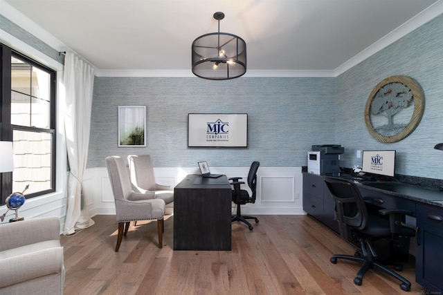 office featuring wallpapered walls, wood finished floors, and a healthy amount of sunlight