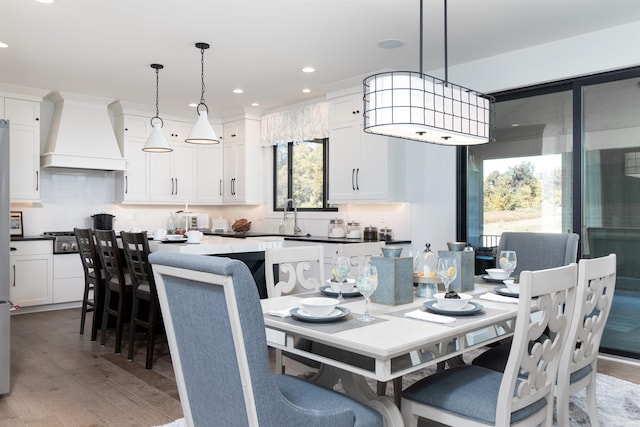 dining room with light wood-style flooring and recessed lighting