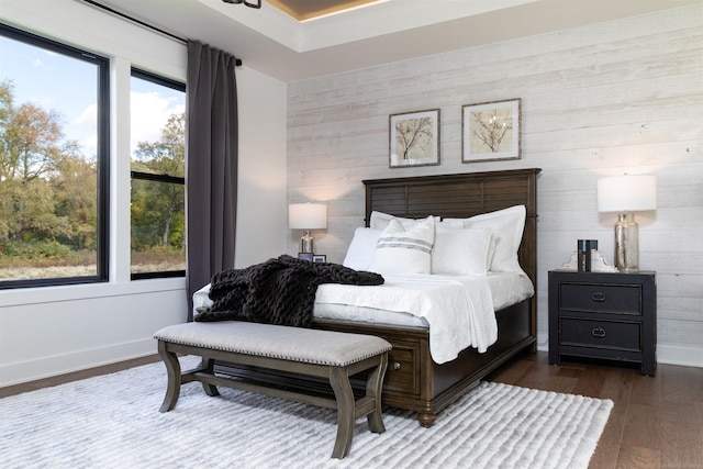 bedroom featuring wood finished floors and baseboards