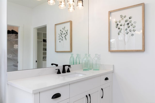 bathroom with a spacious closet and vanity