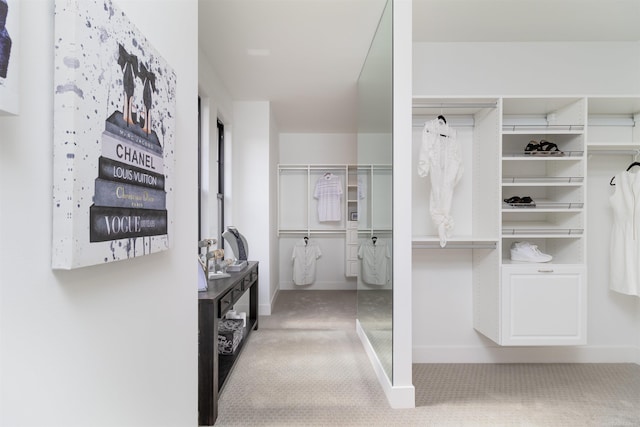 spacious closet with carpet flooring