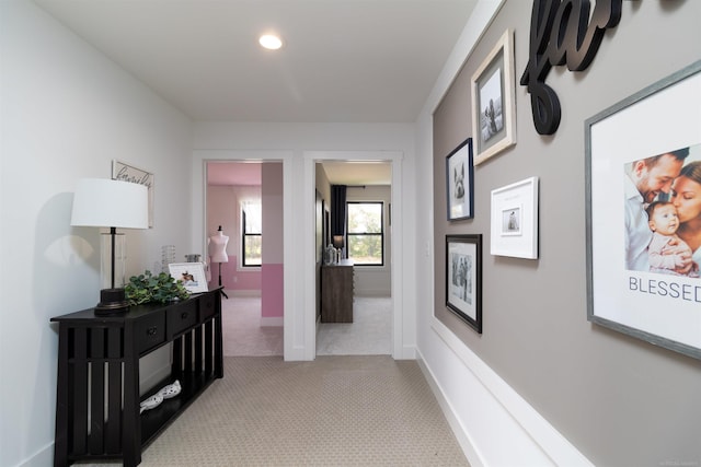 hall with light carpet, baseboards, and recessed lighting