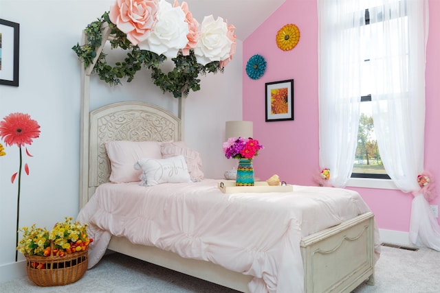 bedroom with light colored carpet, visible vents, and baseboards