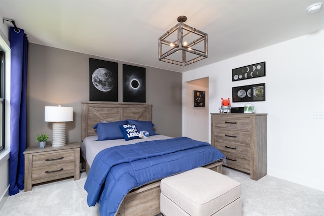 bedroom featuring baseboards, an inviting chandelier, and light colored carpet