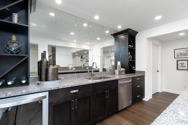 bar with dark wood-style flooring, recessed lighting, stainless steel dishwasher, a sink, and beverage cooler