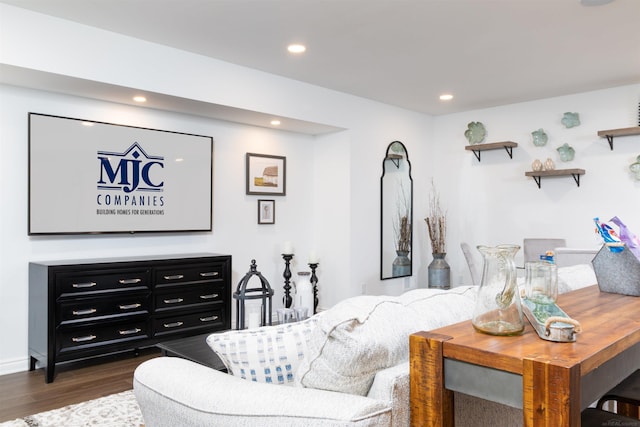 living room with dark wood-style flooring and recessed lighting