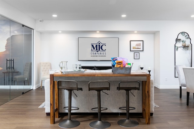 bar with baseboards, dark wood-type flooring, and recessed lighting