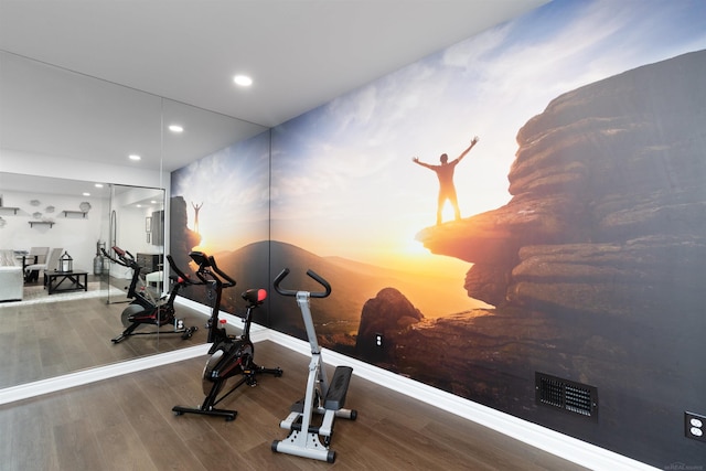 exercise room featuring baseboards, wood finished floors, visible vents, and recessed lighting