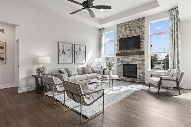 3888 Chatham Pl Unit 99, Brighton, MI 48114 - living area featuring dark wood-style floors, baseboards, and a tray ceiling