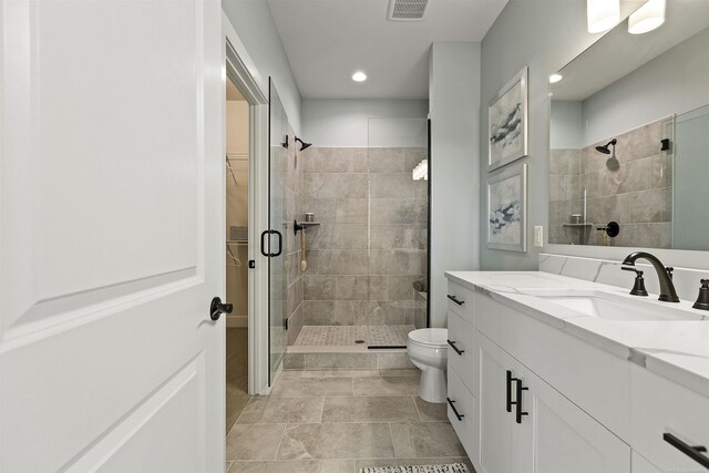 3888 Chatham Pl Unit 99, Brighton, MI 48114 - full bath featuring visible vents, toilet, a walk in closet, vanity, and a shower stall