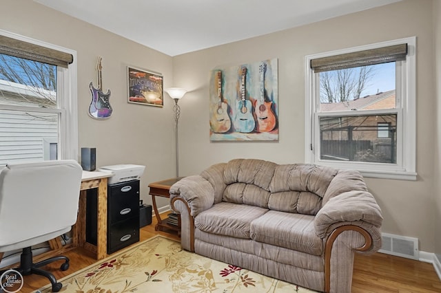 office featuring visible vents, light wood-style flooring, and baseboards