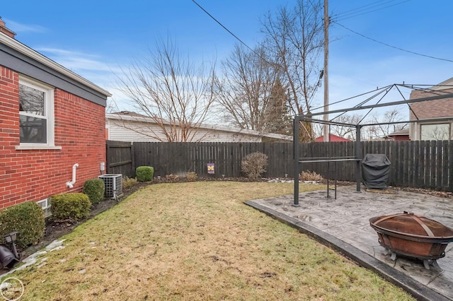 view of yard featuring a fire pit, a patio, a fenced backyard, and cooling unit