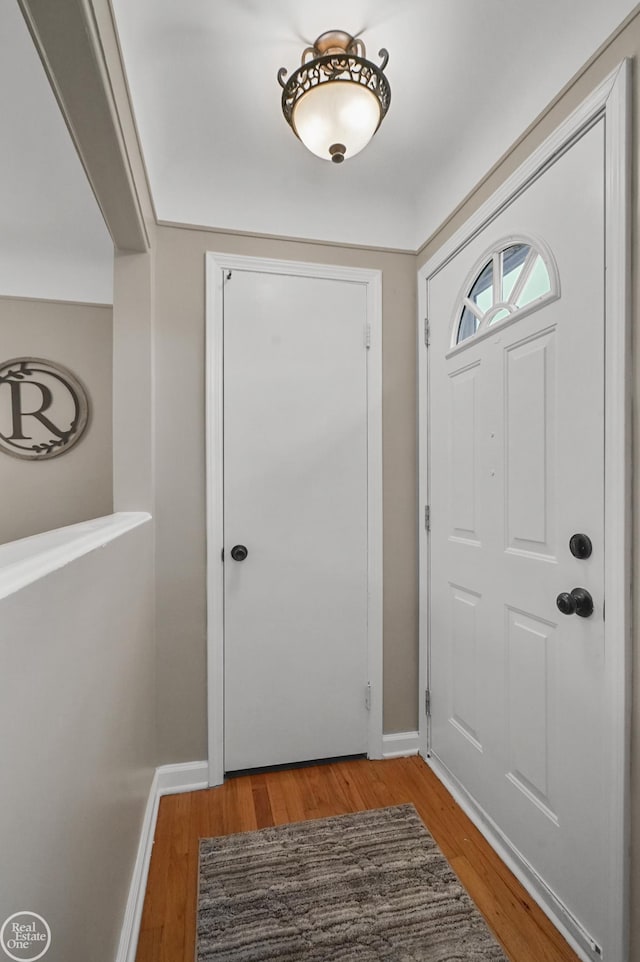 foyer featuring light wood-style flooring and baseboards