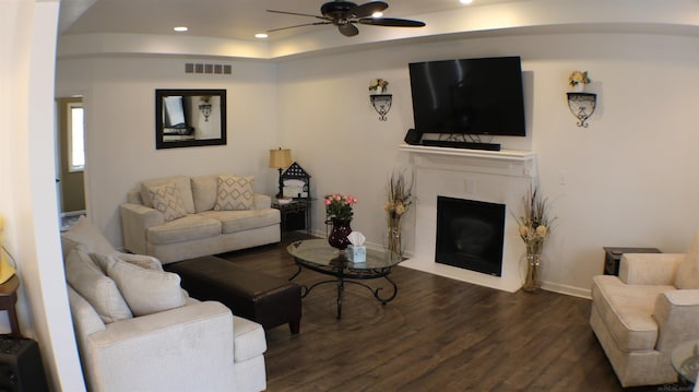 living area featuring ceiling fan, a tile fireplace, recessed lighting, wood finished floors, and visible vents