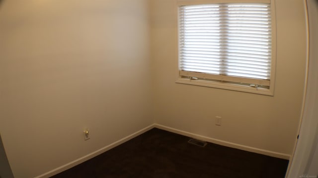 spare room featuring baseboards and visible vents