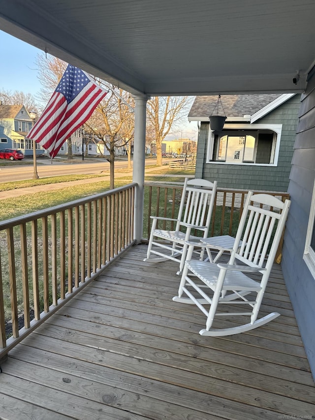 deck with covered porch and a lawn