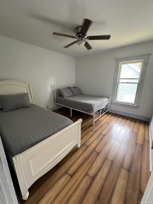 bedroom with ceiling fan and wood finished floors