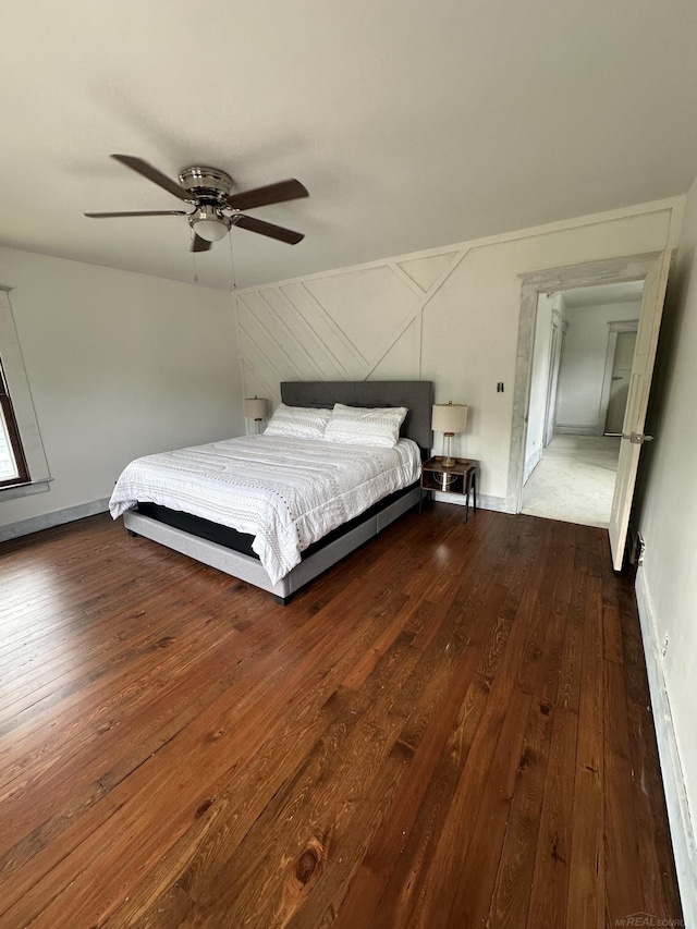 unfurnished bedroom with ceiling fan, baseboards, and hardwood / wood-style flooring