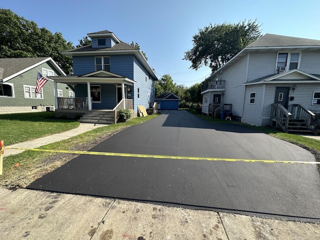 view of front of property with aphalt driveway and covered porch