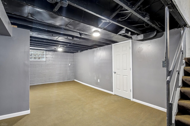 basement with stairway and baseboards