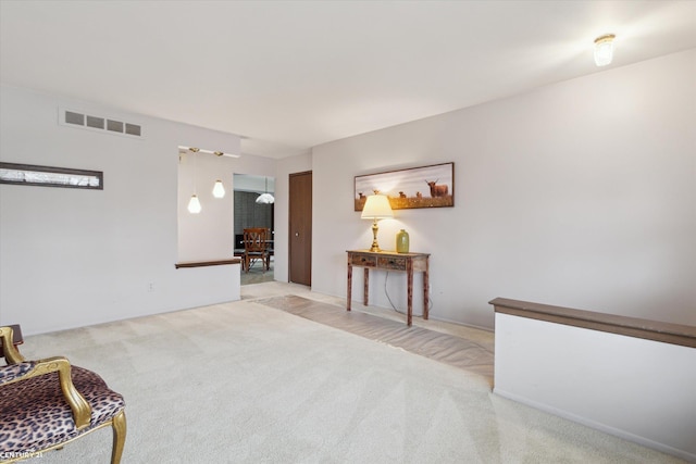 living area with carpet flooring and visible vents