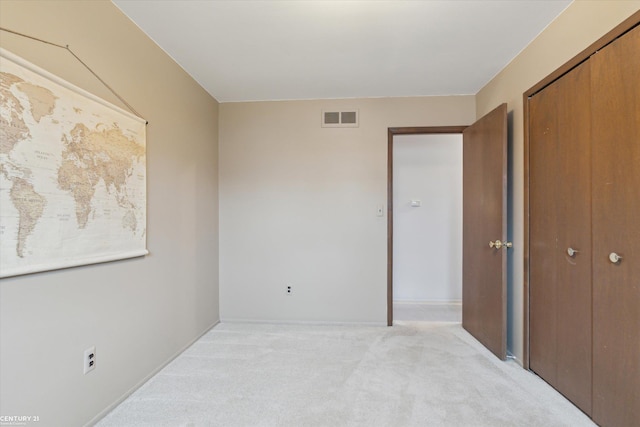 carpeted bedroom featuring visible vents and a closet