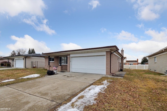 ranch-style home with brick siding, fence, a garage, driveway, and a front lawn