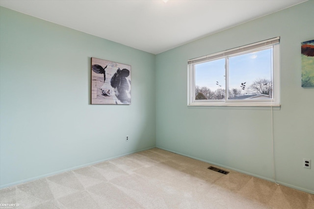 empty room with visible vents and light carpet