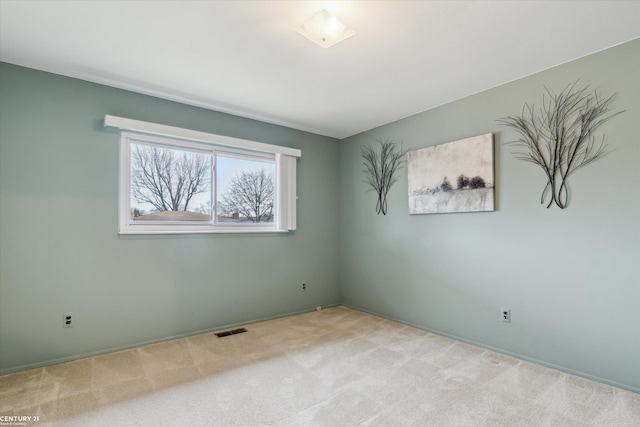 carpeted spare room with visible vents