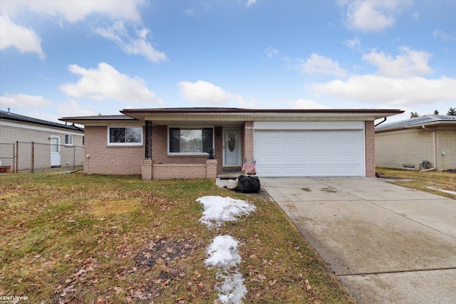 ranch-style house featuring brick siding, concrete driveway, fence, a garage, and a front lawn