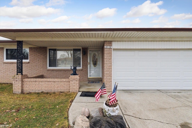 view of front of house featuring a garage, driveway, and brick siding