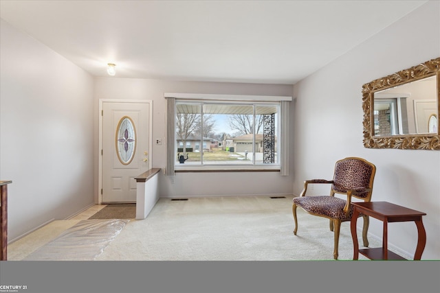 carpeted entrance foyer featuring visible vents