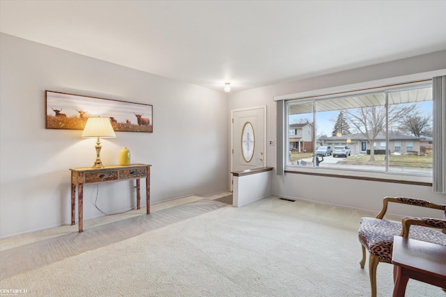 living area featuring carpet flooring and visible vents