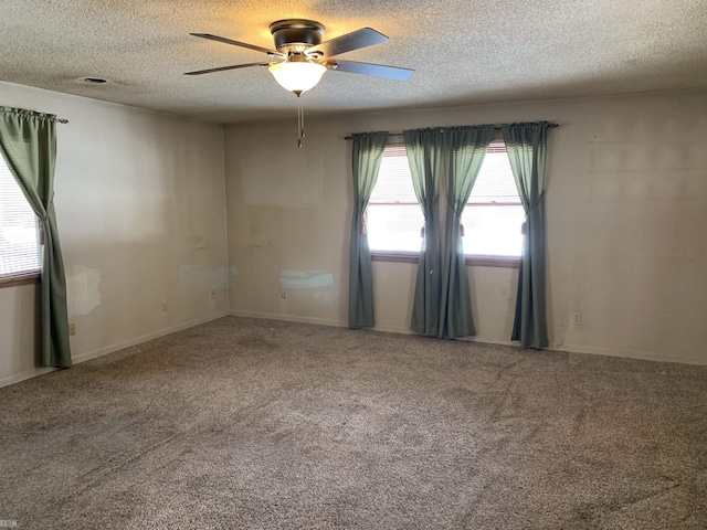 carpeted empty room with a ceiling fan and a textured ceiling